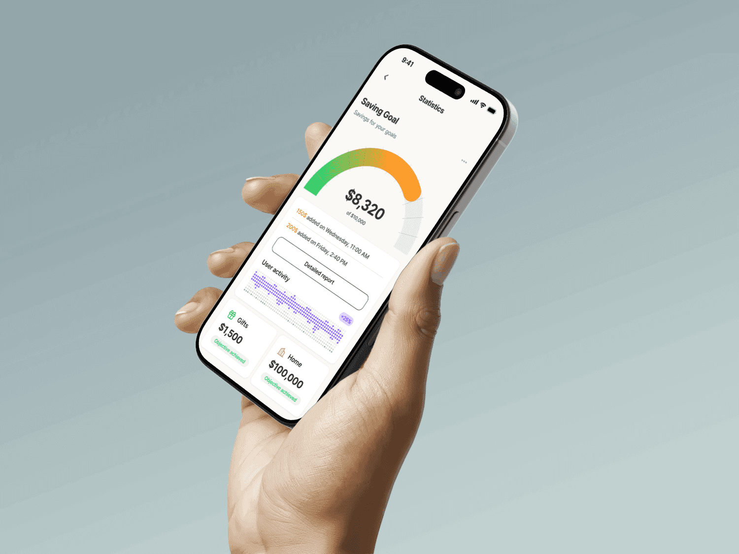 Hand holding phone with saving goal app interface. Financial planning concept.
